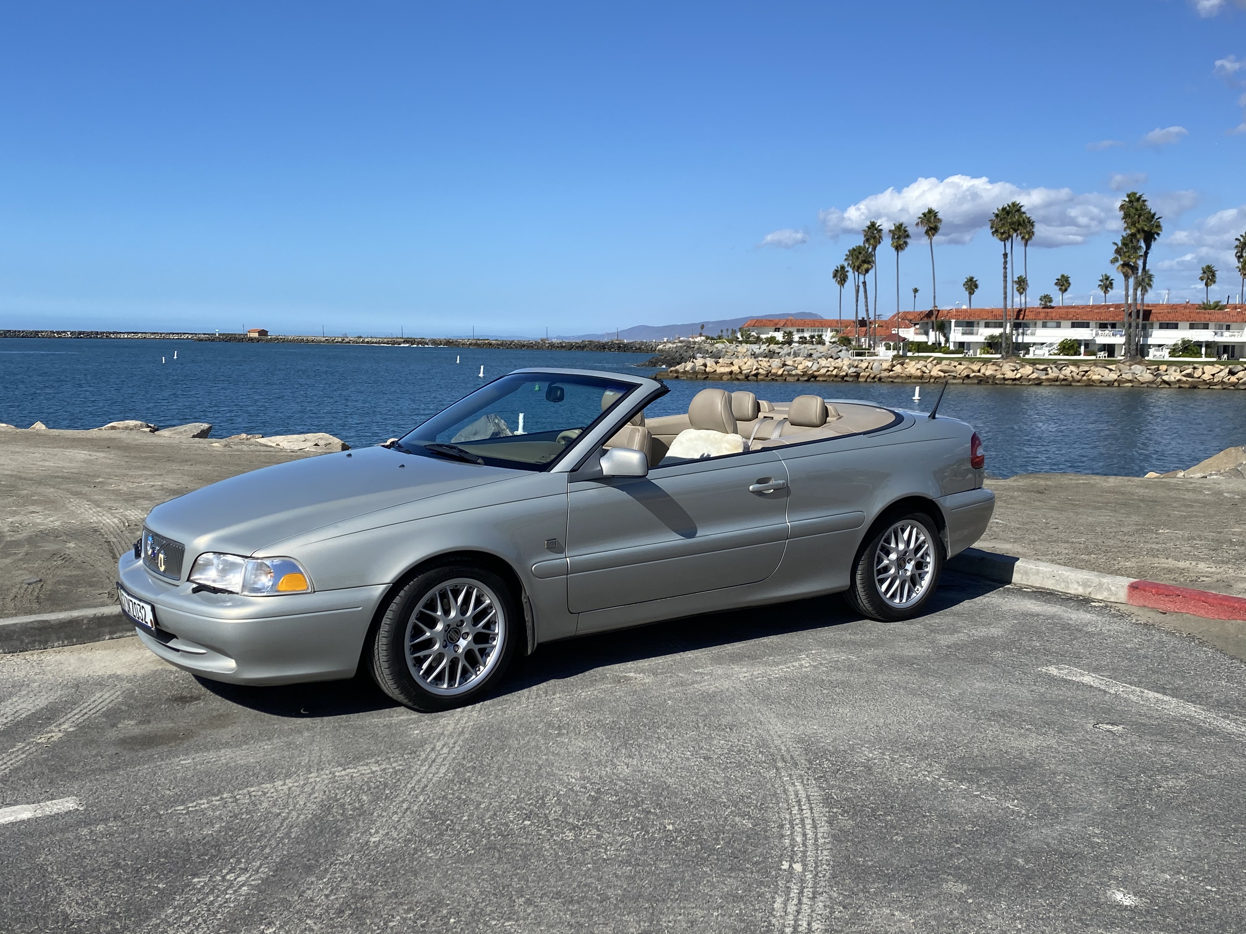 A car parked on a road by the waterDescription automatically generated with low confidence